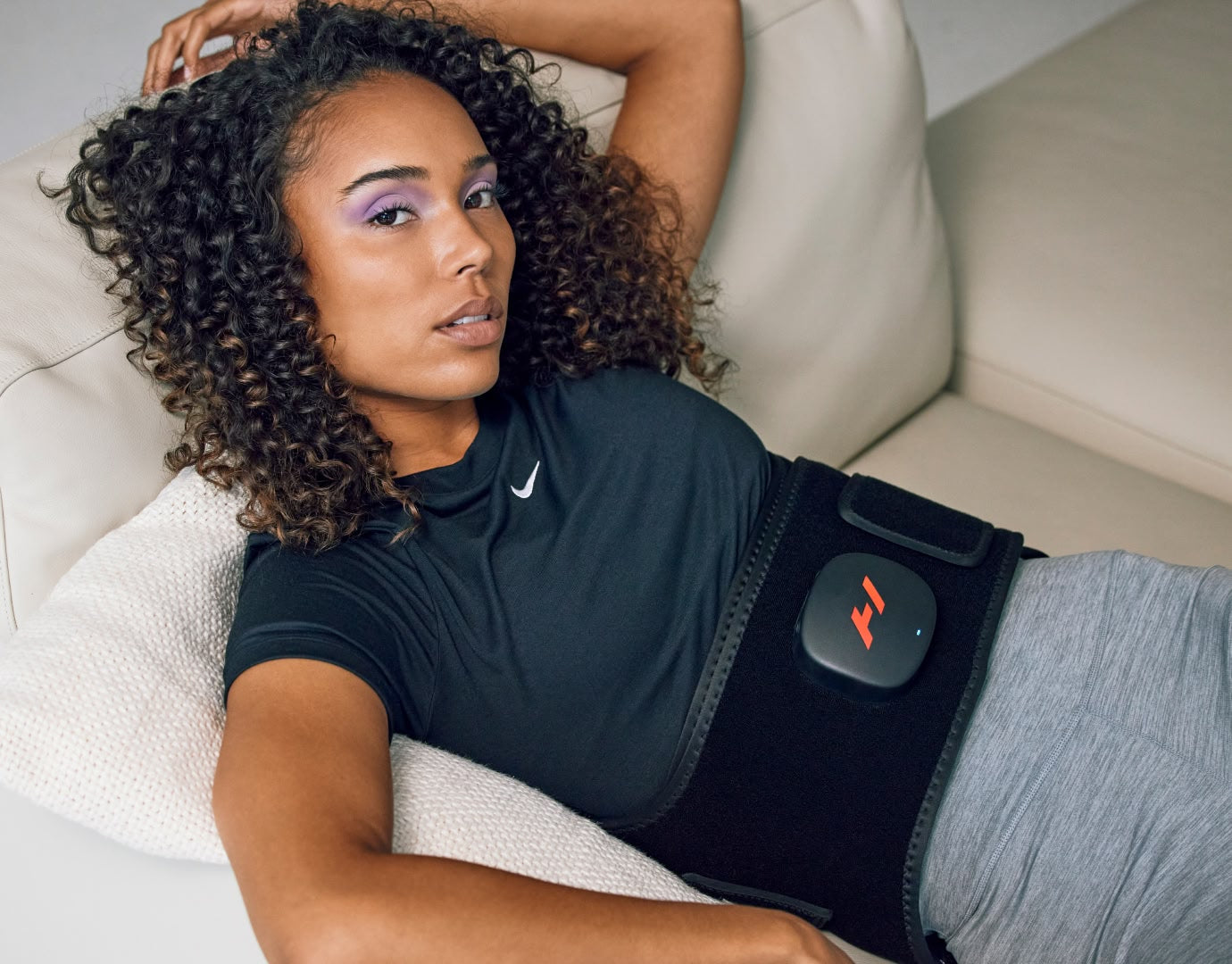 Woman laying on couch with venom 2 back wrapped around waist.