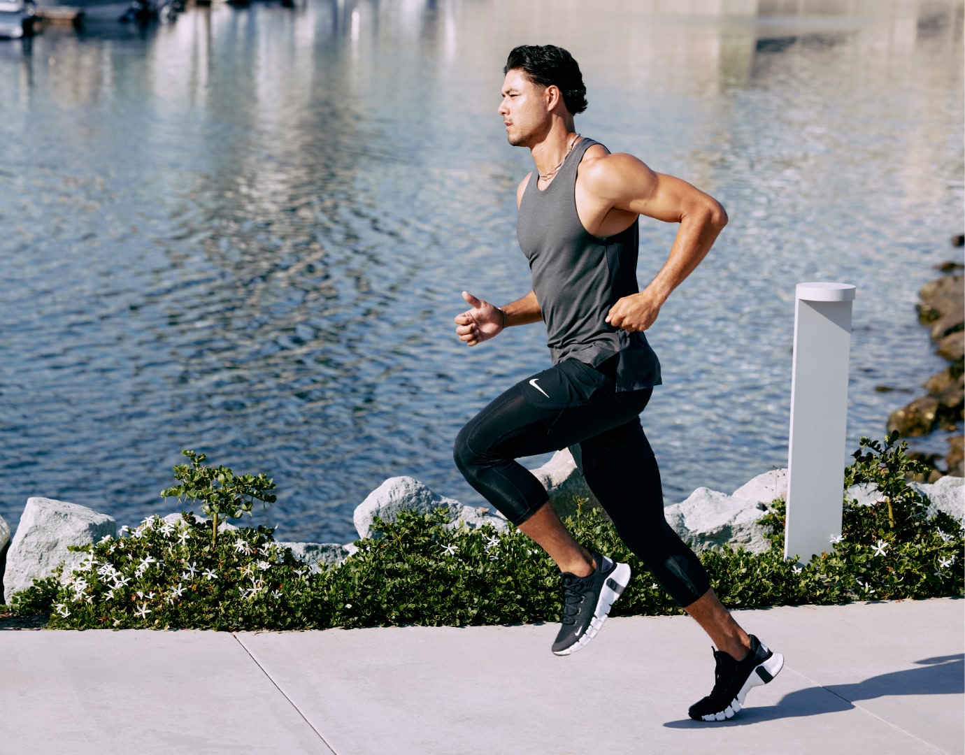 Man outdoors running beside a river.