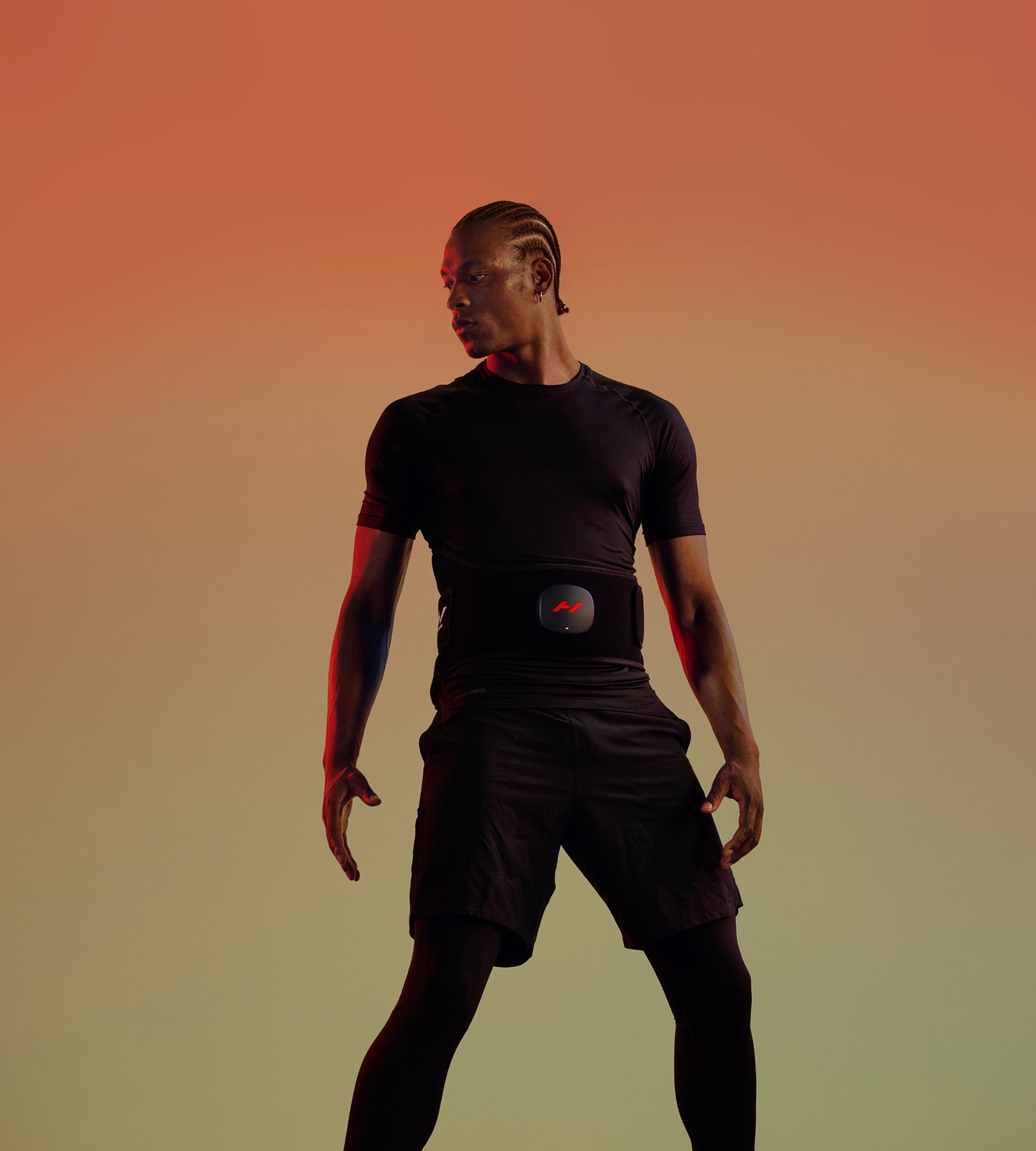 Person wearing a black outfit with a Venom 2 Back on, on an orange and green gradient background