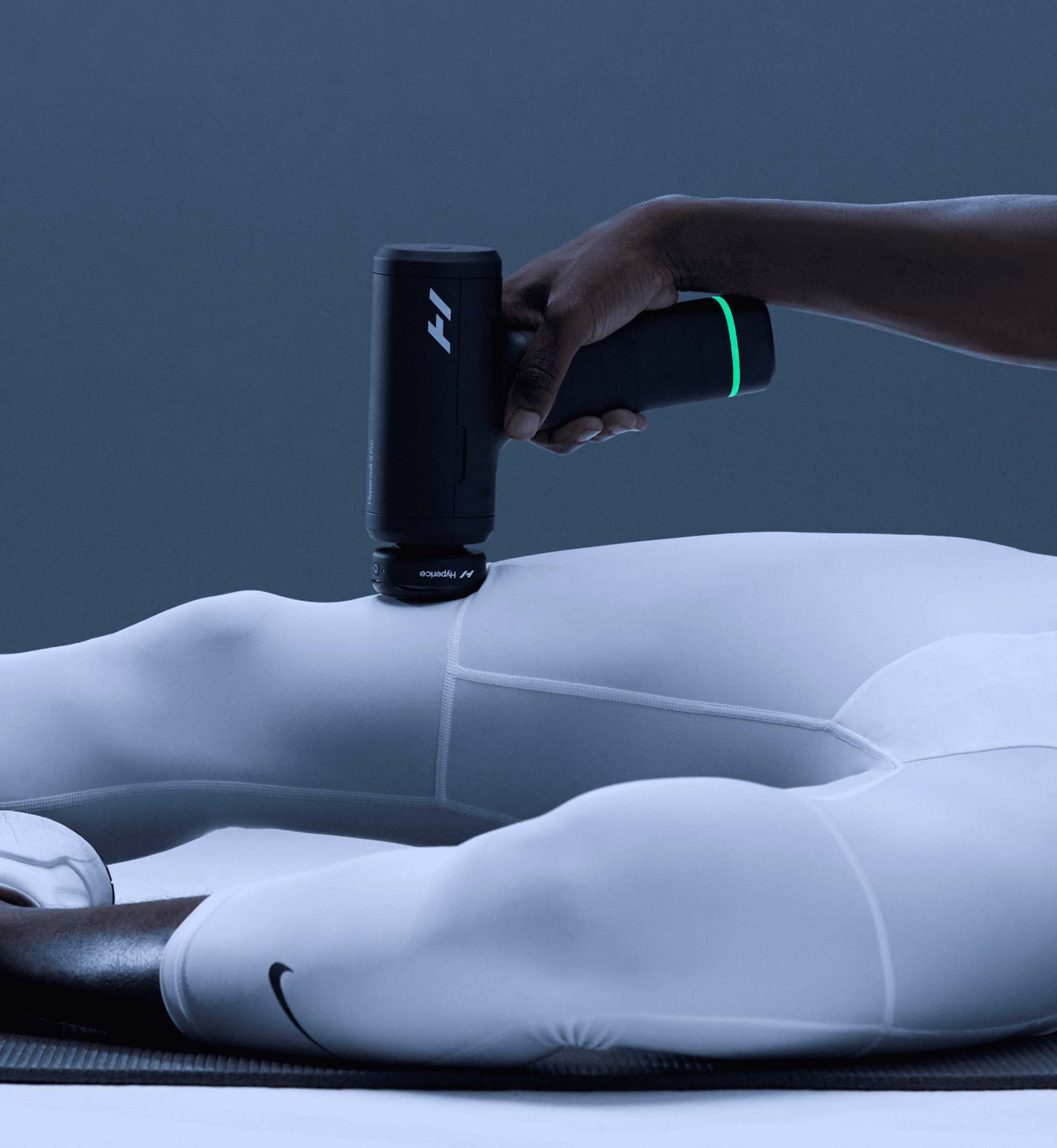 Person using a Hypervolt with the Heated Head Attachment 3 on their quad