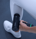 Person using a Hyperice Go 3 massage device on their leg.