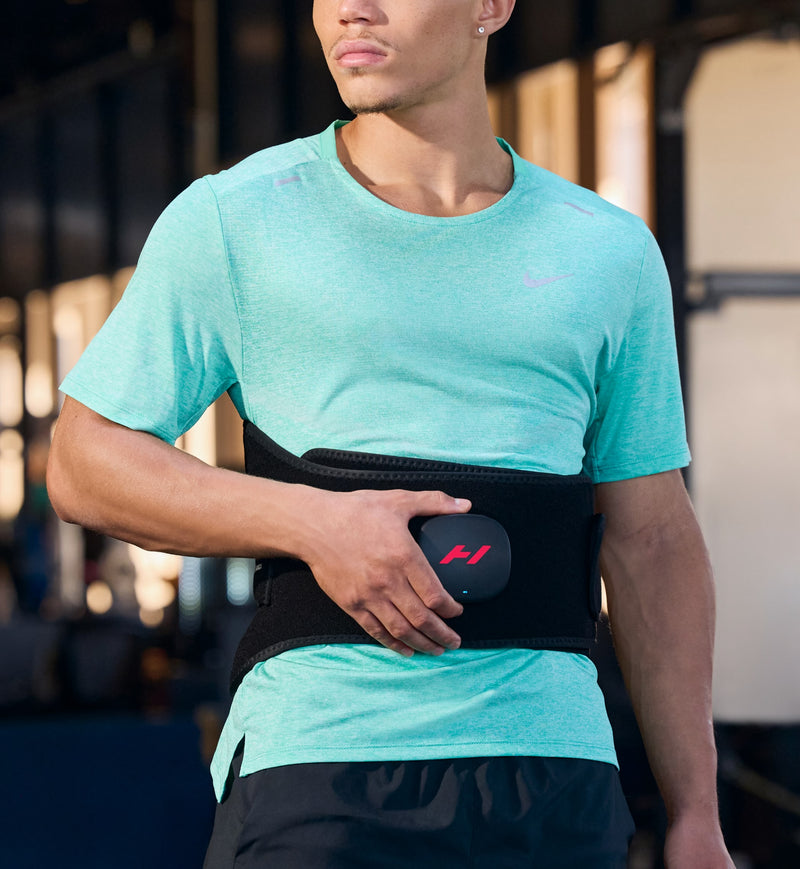 Person wearing a turquoise athletic shirt and venom 2 back with a blurred background